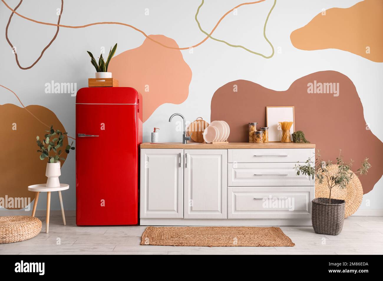 Interior of stylish kitchen with retro fridge, counters and houseplants ...