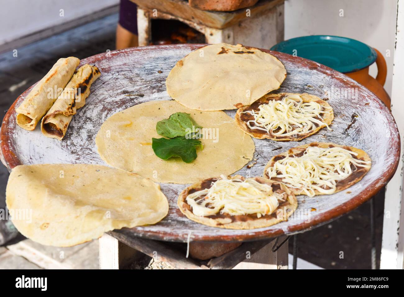 Tlayudas (big roasted tortillas) at a street food stall in Oaxaca city Mexico Stock Photo