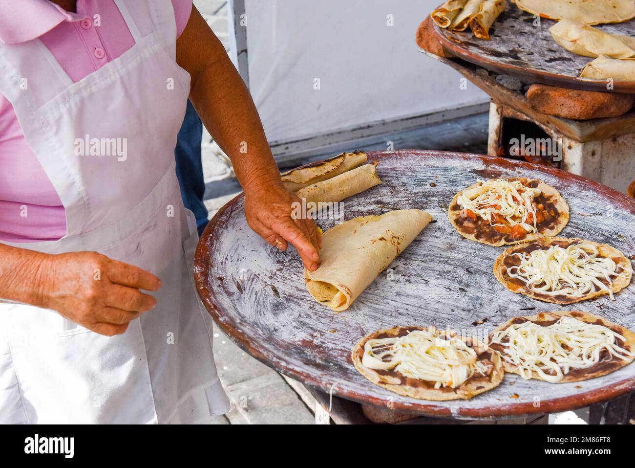 Tlayudas being prepared at a street food stall in Oaxaca city Mexico Stock Photo