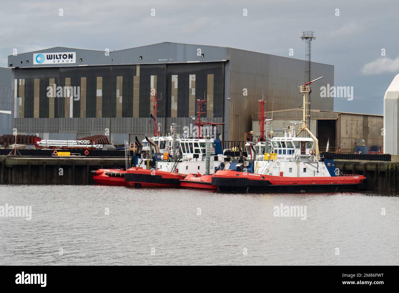 Harbour tugs 'Roman' 'Marksman' 'Guardsman' and 'Nobleman' moored to the North Bank of the River Tees in Middlesbrough Stock Photo
