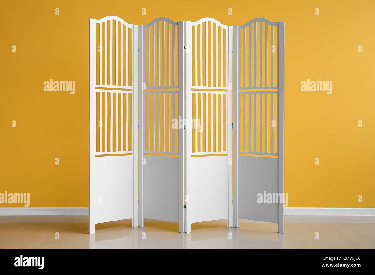 White folding screen near yellow wall Stock Photo - Alamy