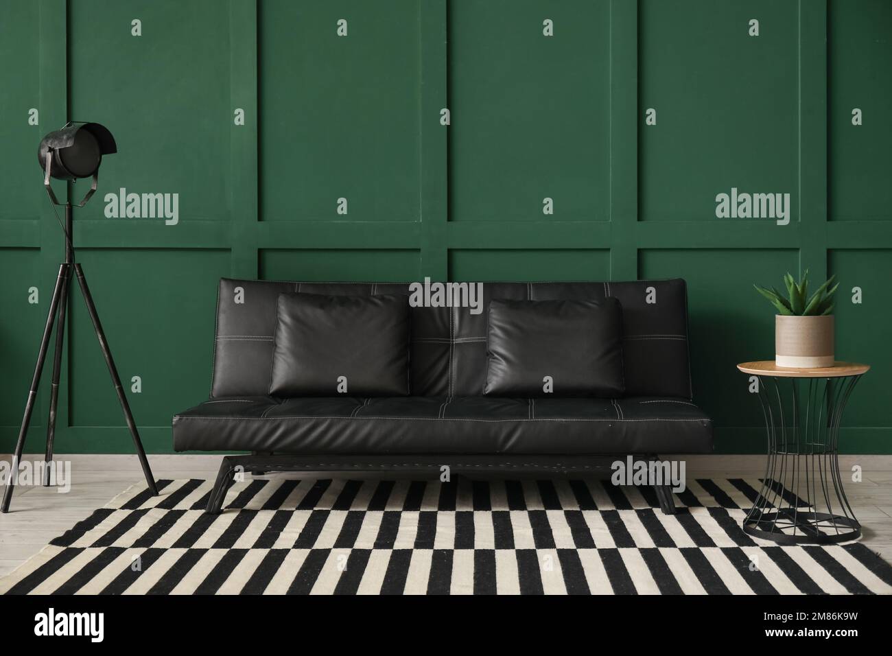 Interior of living room with black couch, lamp and table Stock Photo ...