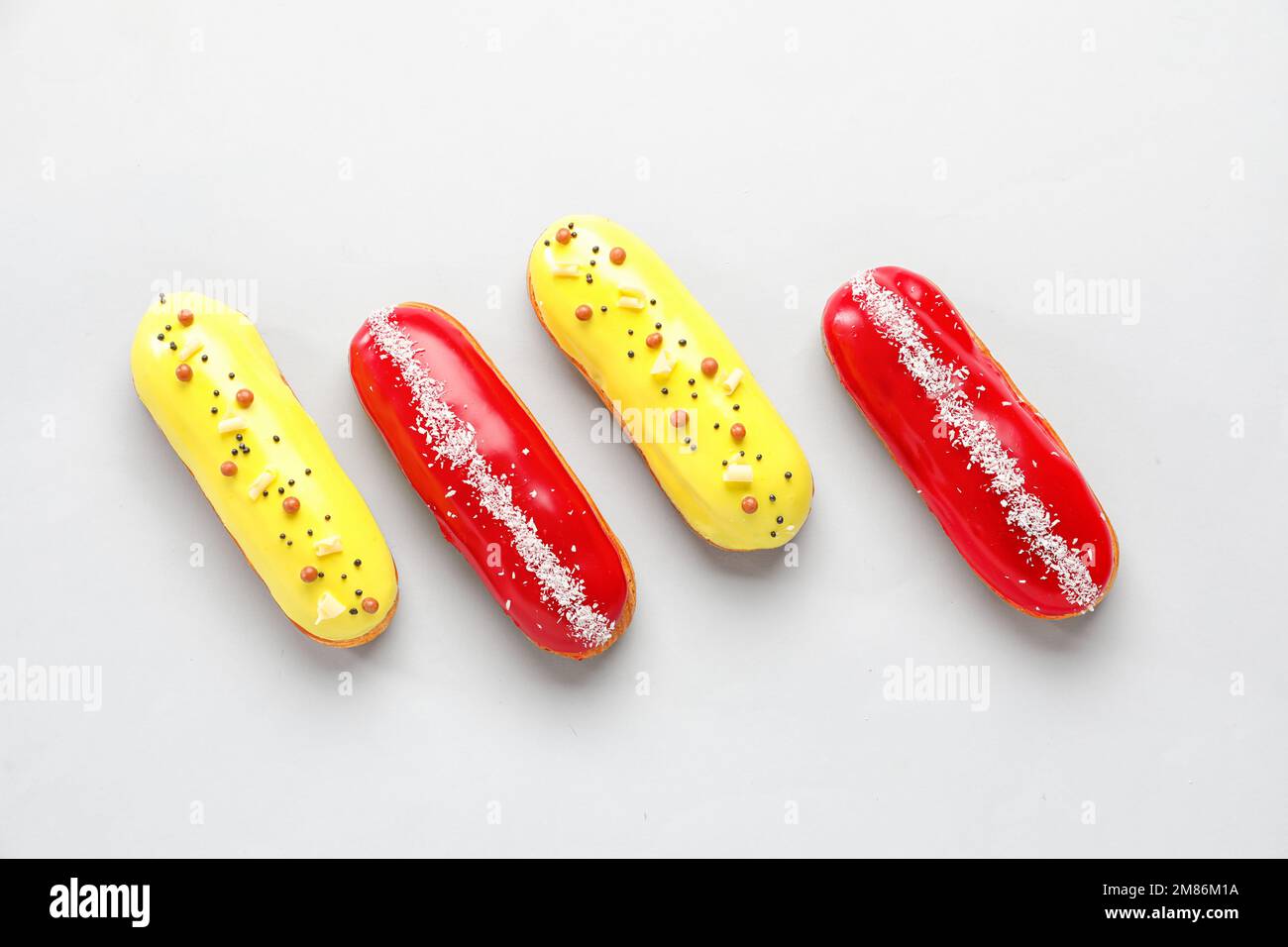 Delicious glazed eclairs isolated on white background Stock Photo