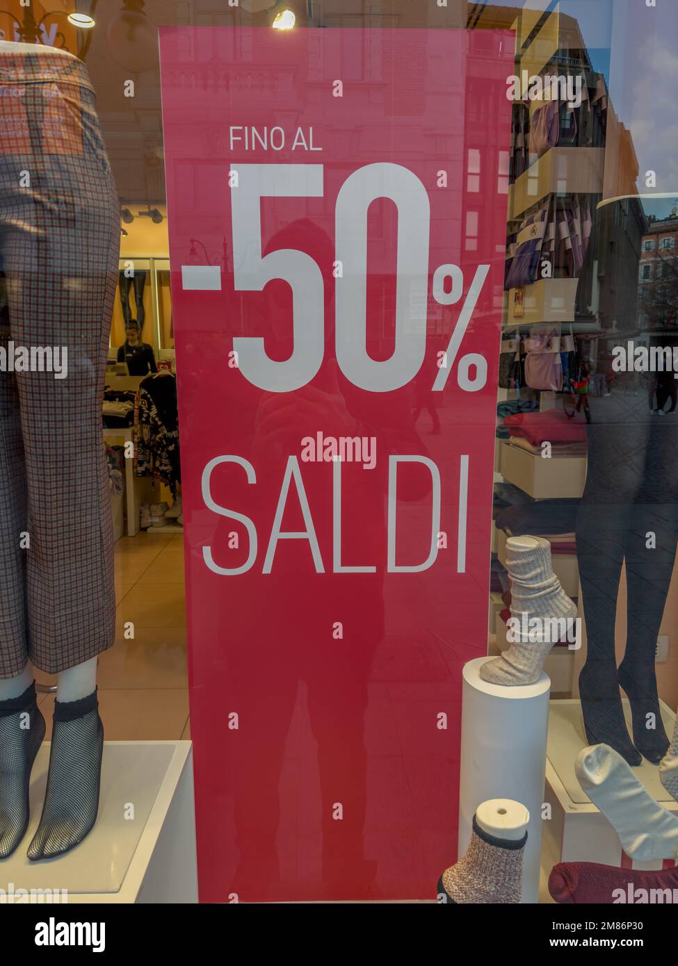 a shop window displaying the winter Sales, 'Saldi', in Milano's central Via Dante, Milan, Italy Stock Photo