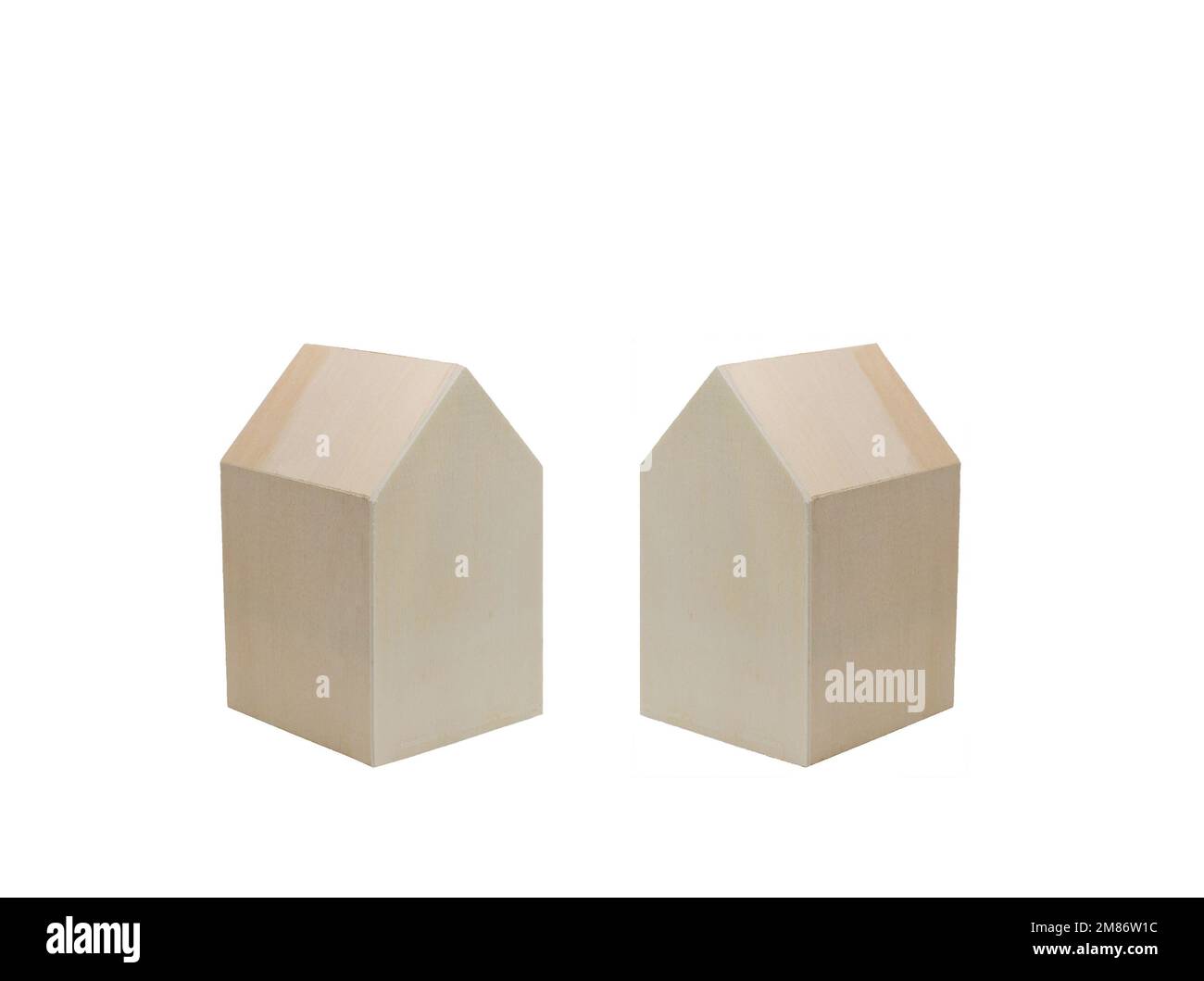 Pair of wooden house shapes on a plain white background. Housing concept. Copy space. No people. Stock Photo