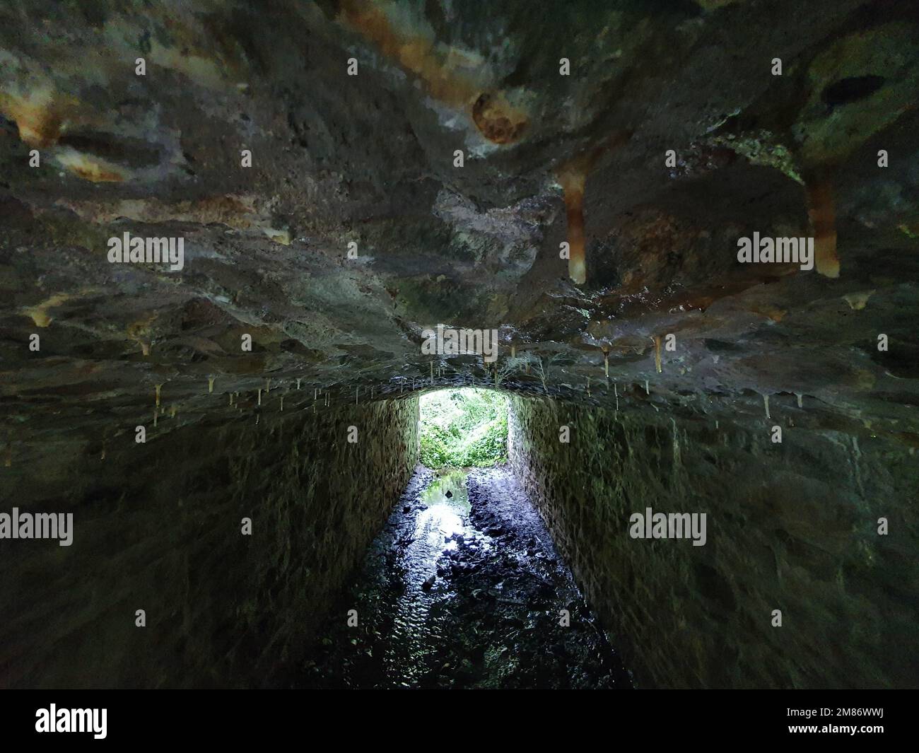 A closeup shot of an old stone tunnel with a lot of water erosion Stock