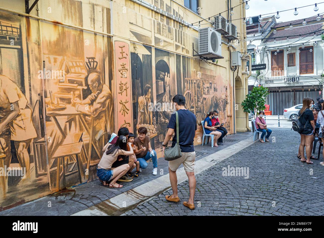 Kuala Lumpur, Malaysia  - December 12th , 2022 : KWAI CHAI HONG, alley behind Petaling Street with murals depicting the daily life of Chinatown Stock Photo