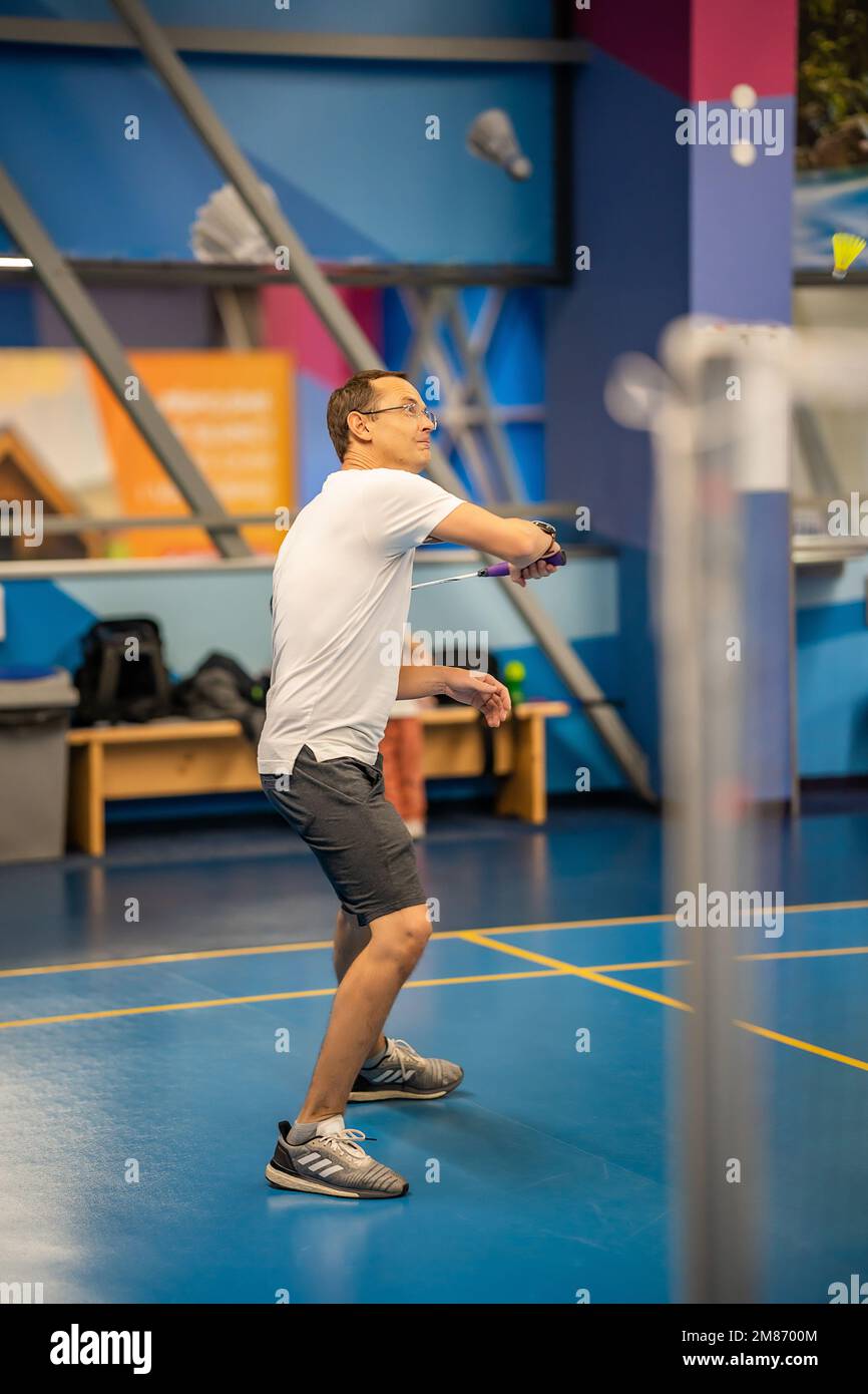 Man playing badminton in sport wear on indoor court Stock Photo - Alamy