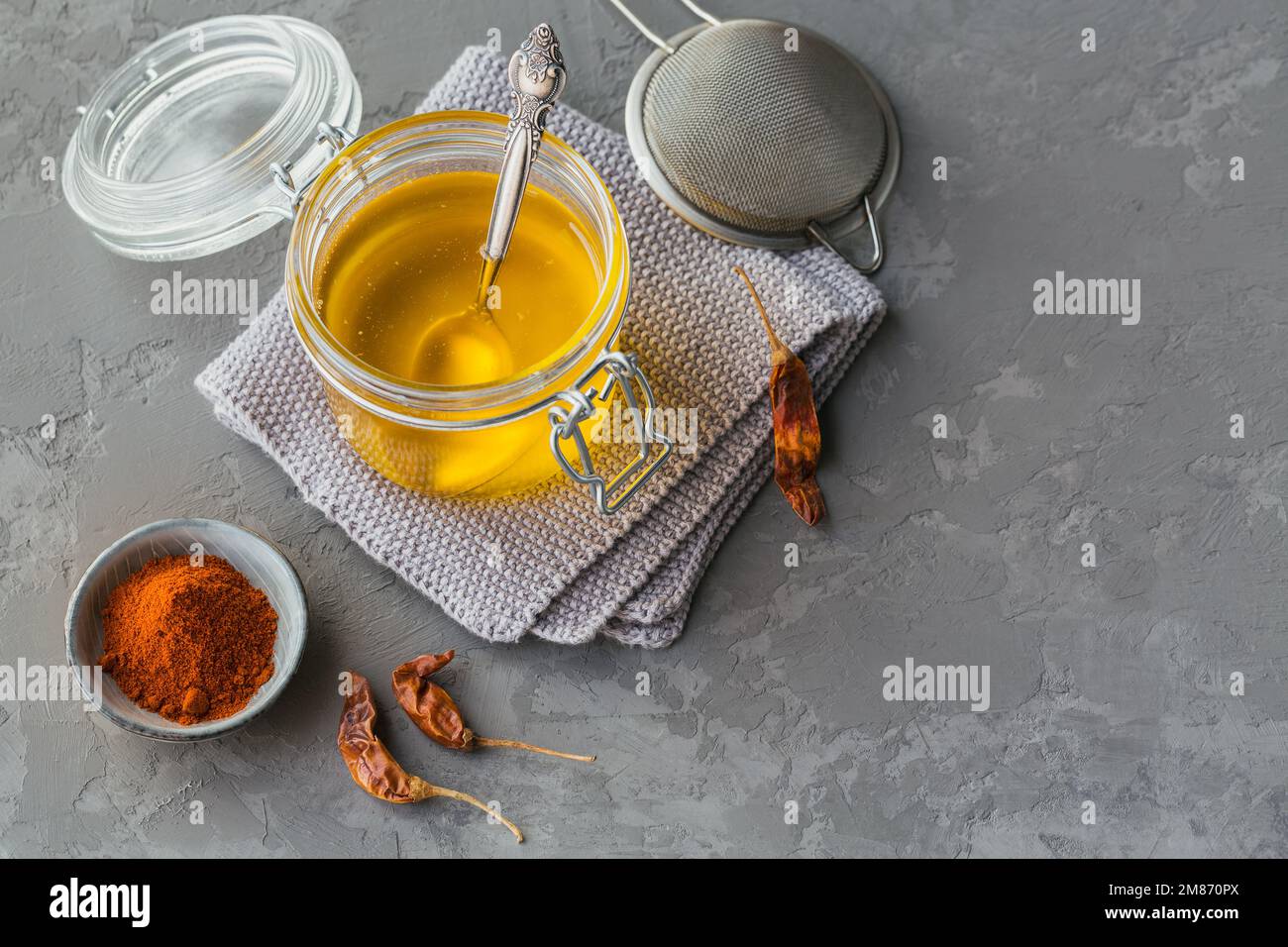 Homemade Ghee or clarified butter in a jar, chili and paprika powder on ...