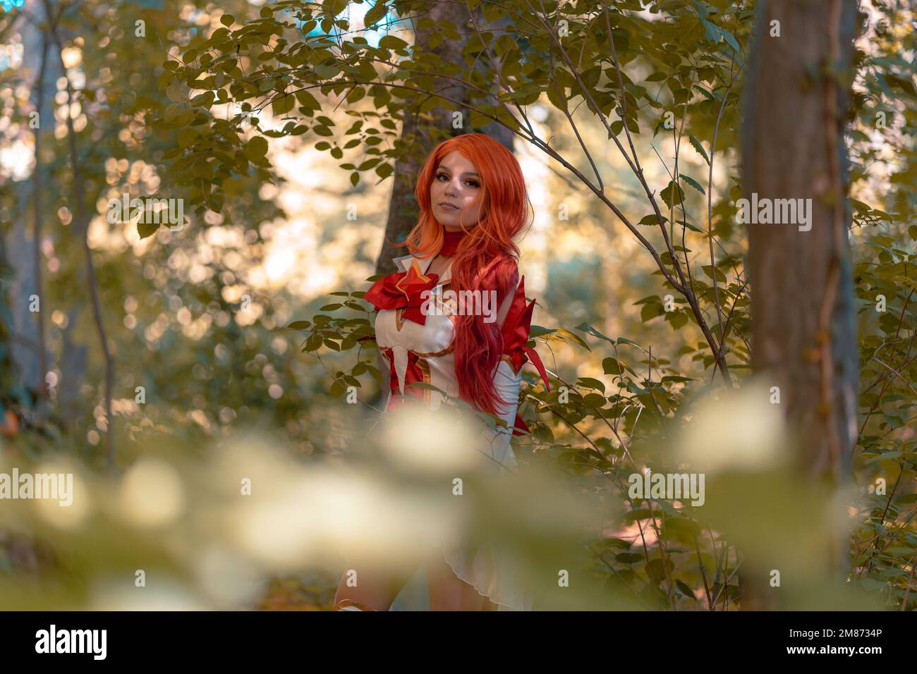 A  Caucasian redhead female playing the cosplay miss fortune from league of legends in the woods Stock Photo