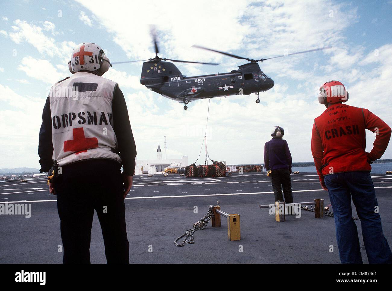 Flight deck crewmen stand by aboard the hospital ship USNS MERCY (TAH