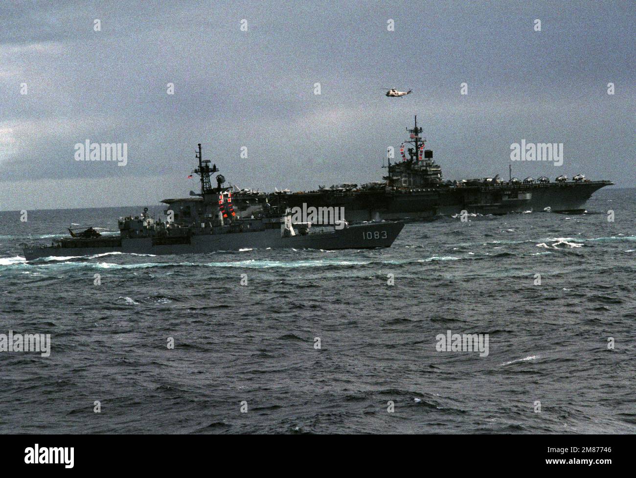 The US Navy (USN) Knox Class Frigate USS COOK (FF 1083) (foreground