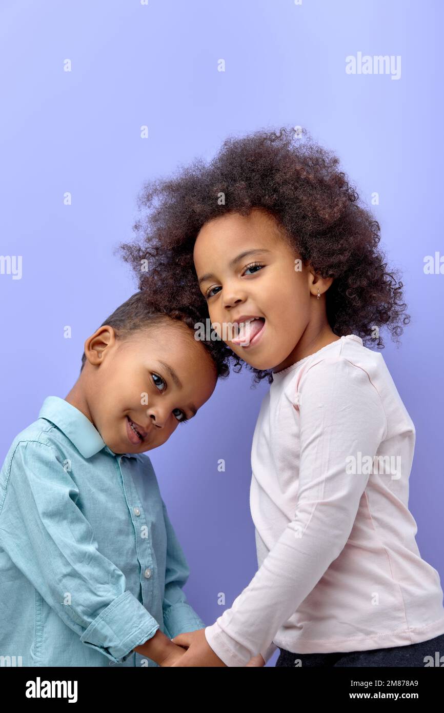 happy black children posing at camera and cheerfully smiling over ...