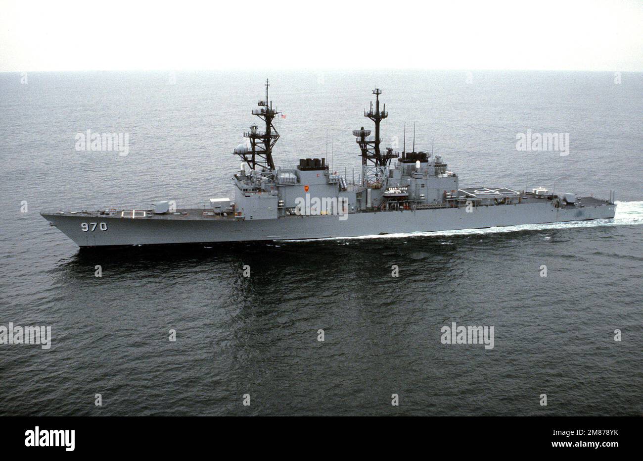 A port view of the destroyer USS CARON (DD-970) underway off the ...
