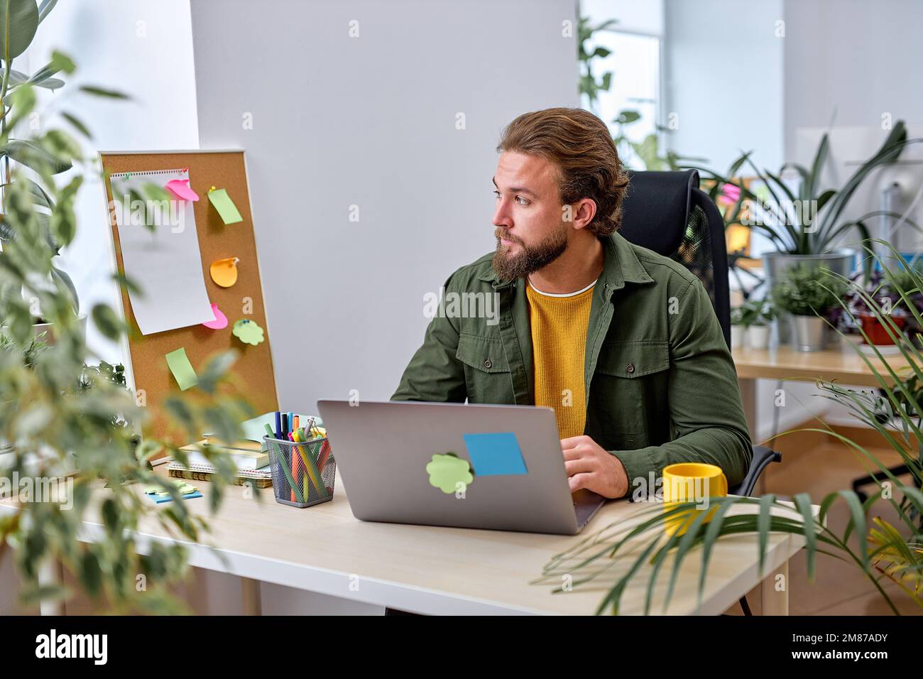 Young Caucasian Male Entrepreneur Working Laptop In Modern Office, Handsome American Or Caucasian Guy Sitting At Desk Checking Financial Reports, Conc Stock Photo