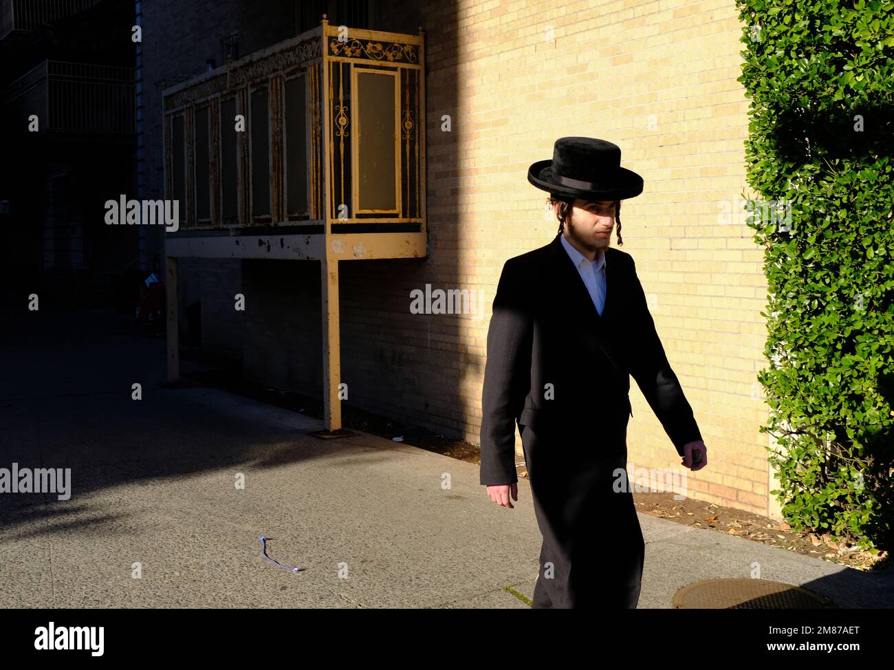 A young Orthodox Jewish man walking on Lee Avenue.Williamsburg.Brooklyn.New York City.USA Stock Photo