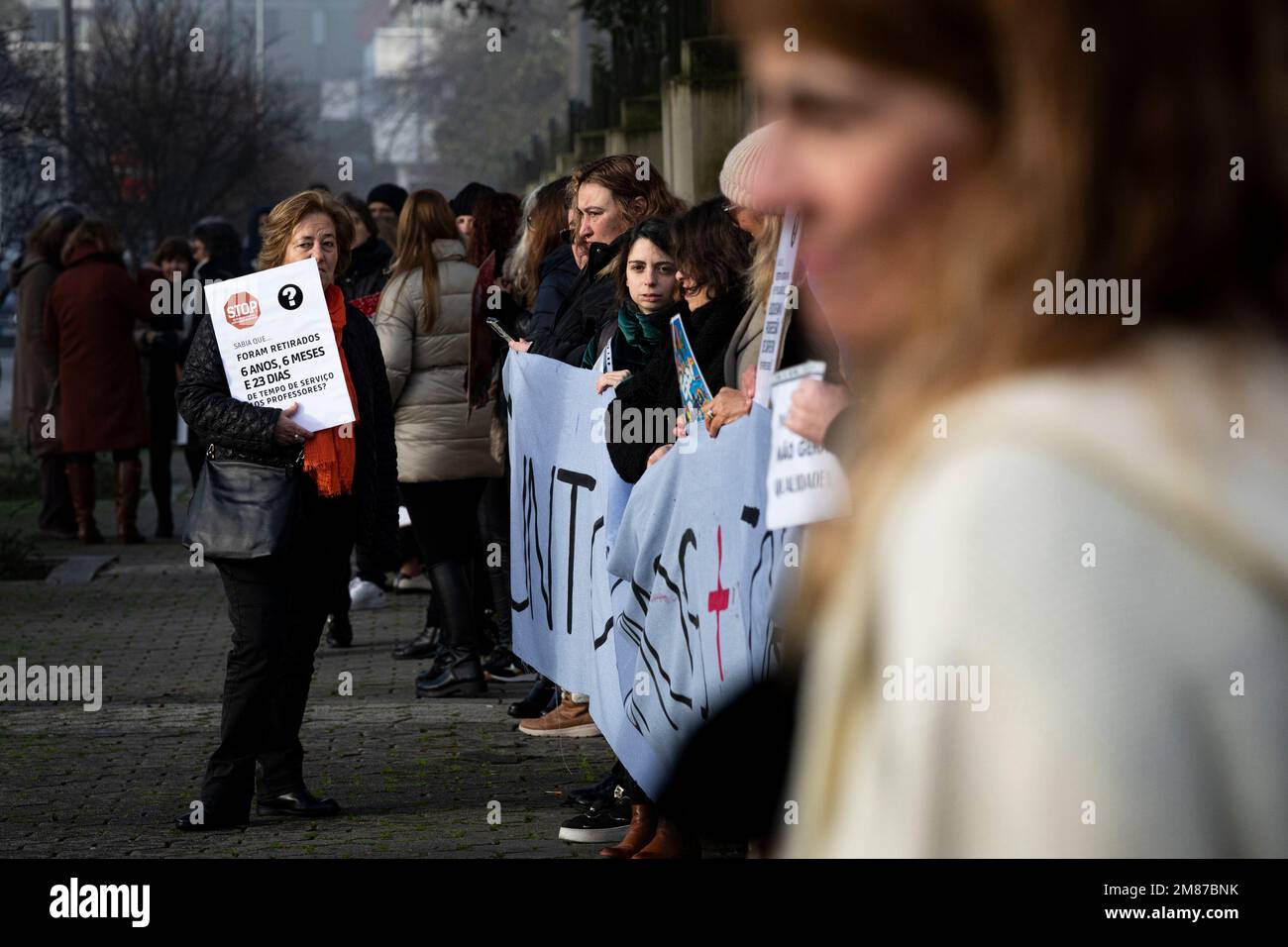 Protesters Hold Placards And A Banner Expressing Their Opinion During