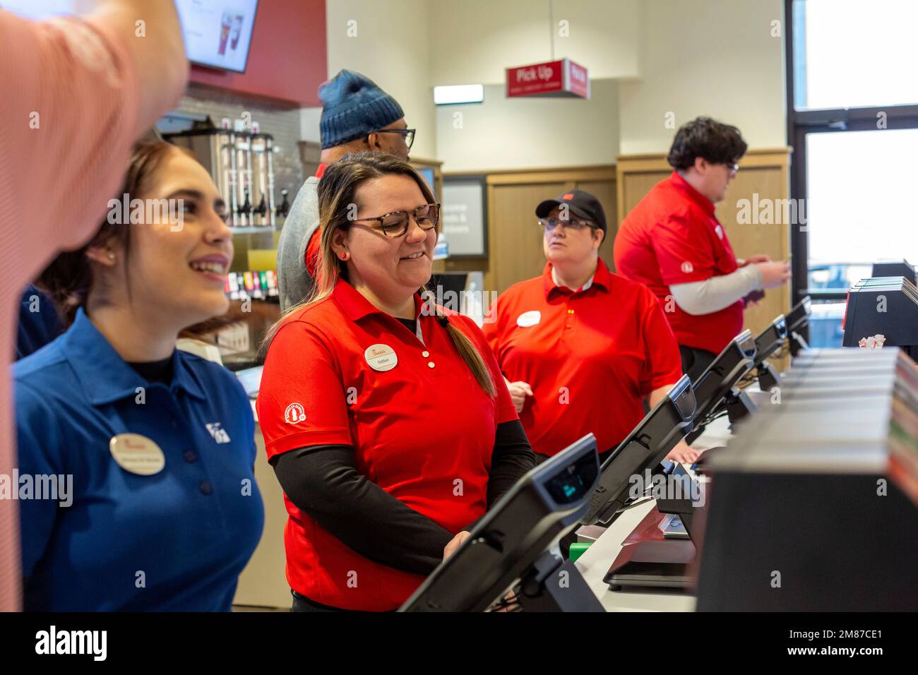 Livonia, Michigan - Workers at Chick-fil-A, on the day of the restaurant's grand opening. Workers in red shirts are the store's new staff, while those Stock Photo