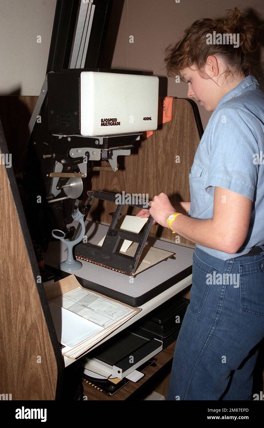Photographer's Mate AIRMAN Michelle Quinn readies an enlarger before