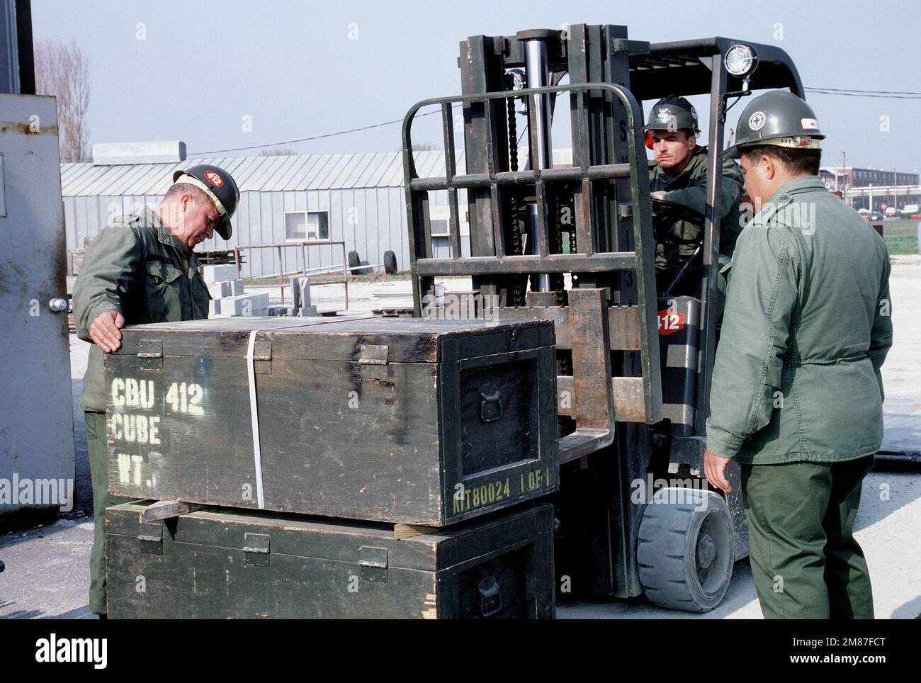 Members of Construction Battalion Unit 412 (CBU-412) use a forklift ...