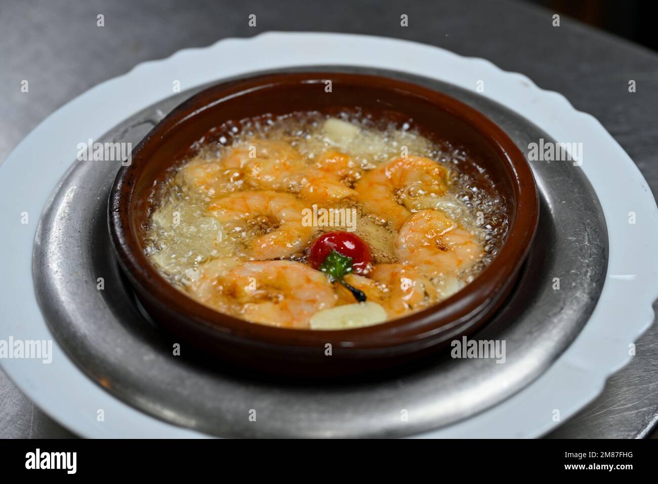 Prawns sizzling in garlic oil while cooking Stock Photo Alamy