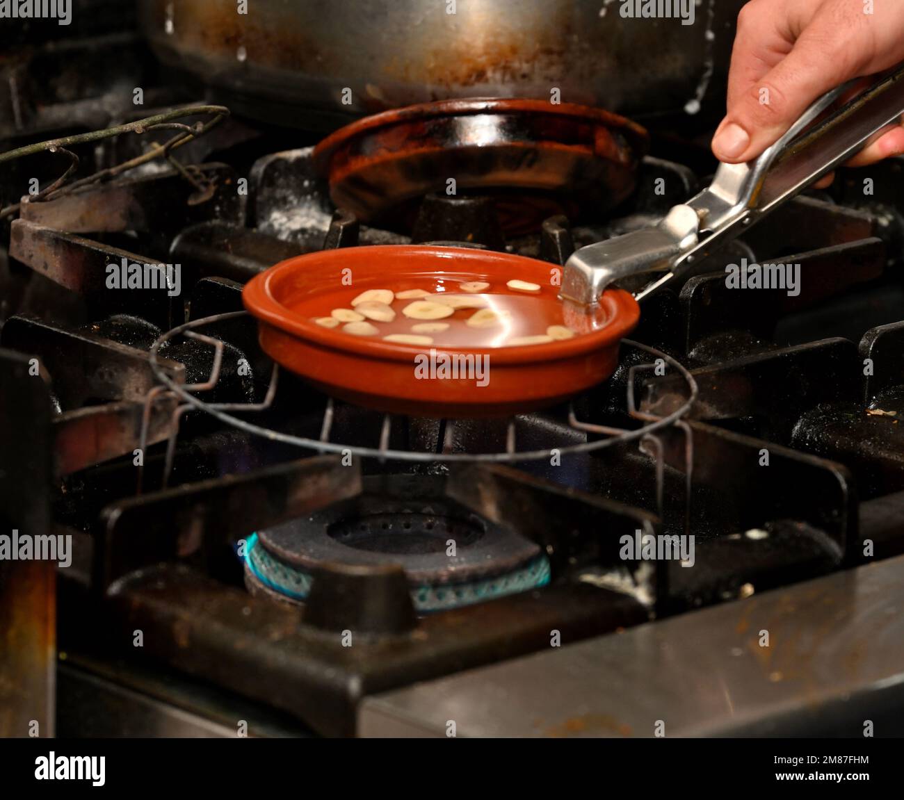 Heating oil for cooking on top of gas hob Stock Photo