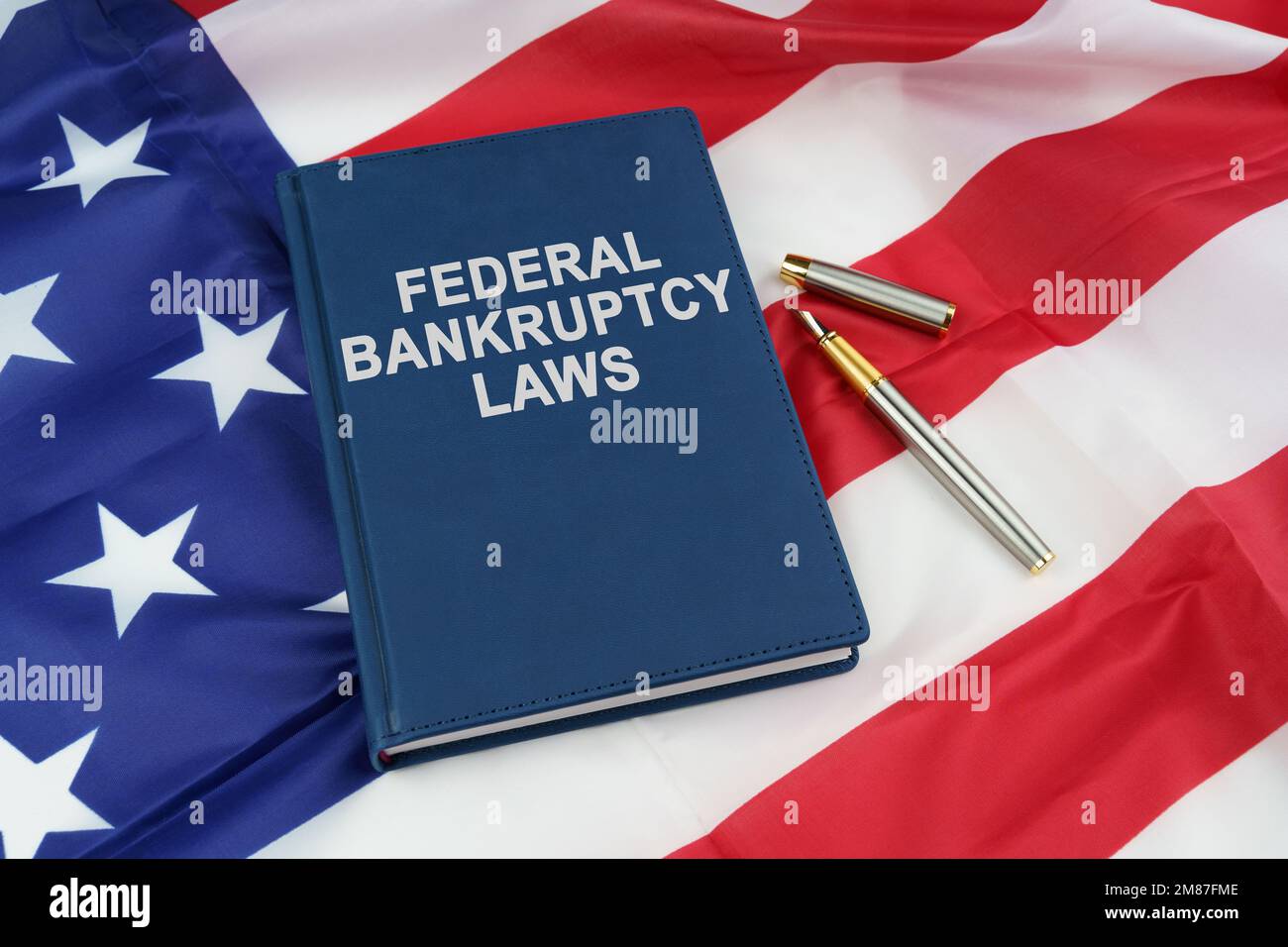 Law concept. On the US flag lies a pen and a book with the inscription