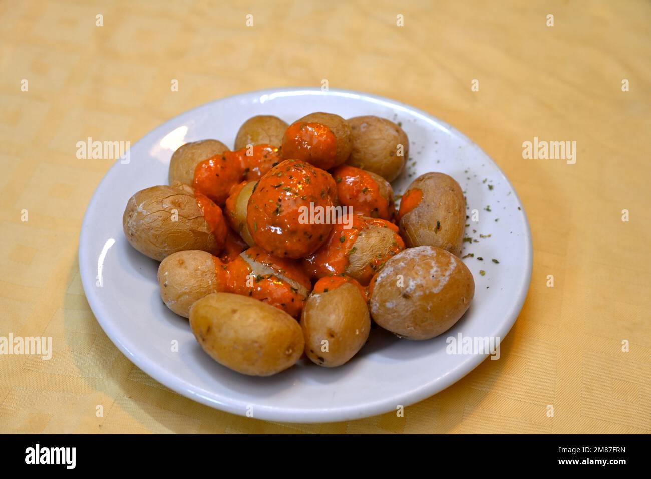 Dish of Papas Arrugadas – Canarian Salt Potatoes (wrinkled Potatoes) with Red Mojo Sauce Stock Photo