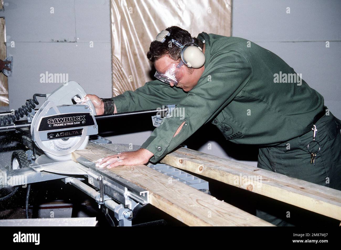 Weps In Construction A Construction Battalion Unit 412 (CBU-412) builder cuts wood to make a ...