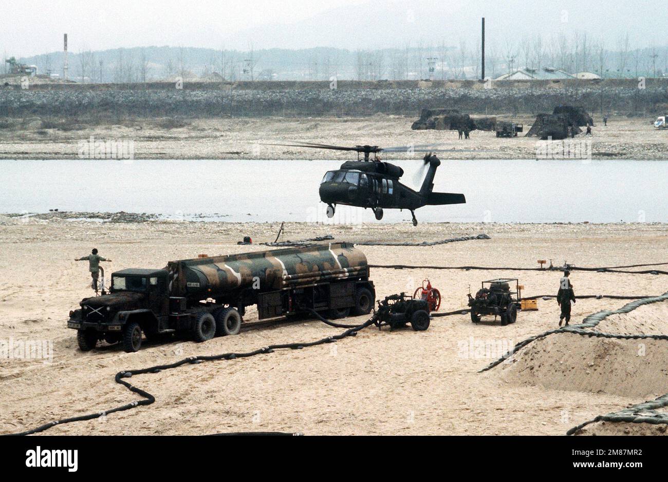 A UH60 Black Hawk (Blackhawk) helicopter lands at a refueling point as
