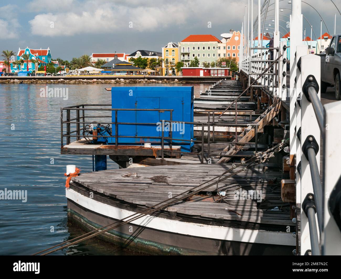 WILLEMSTAD, CURACAO - NOVEMBER 21, 2008: The pontoons of the Queen Emma Bridge in the town centre of Willemstad in Curacao with the colorful houses on Stock Photo