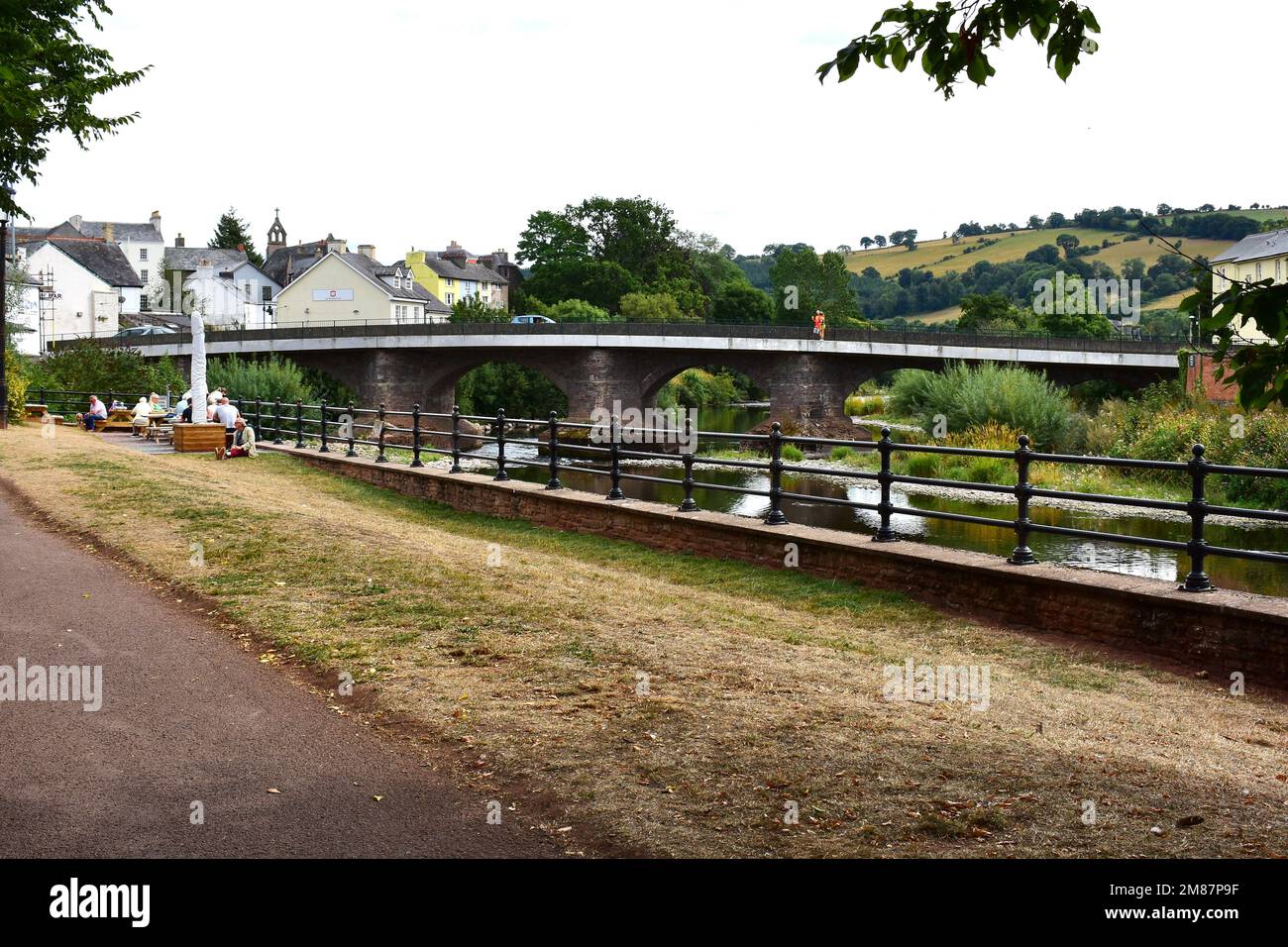 The main road bridge into Brecon town centre, where it crosses over the river Usk. Viewed from The Promenade on the north bank. Stock Photo