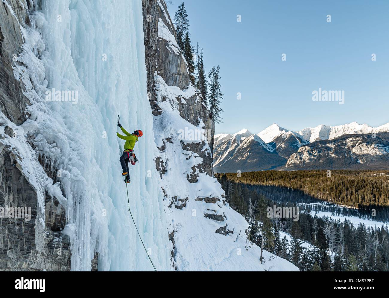 Elijah Weber climbing Carlsberg Column WI5 in British Columbia Canada Stock Photo
