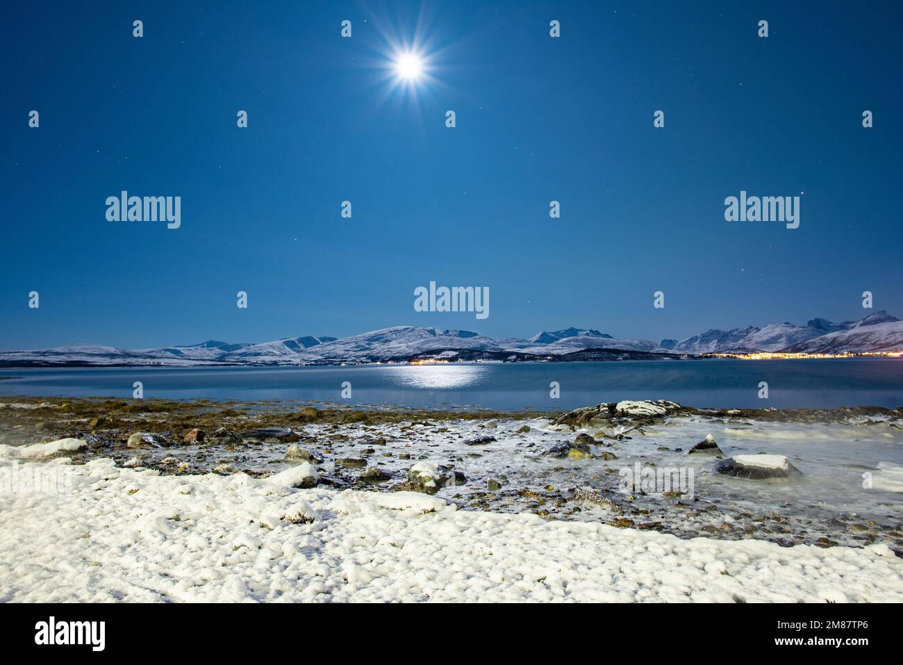 Frozen salt water under full moon, night in the Arctic in freezing conditions, extreme cold Stock Photo