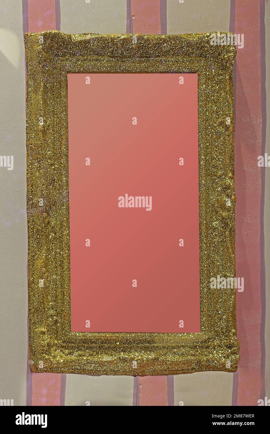 Vintage gold sparkling empty frame hanging on a wall Stock Photo - Alamy