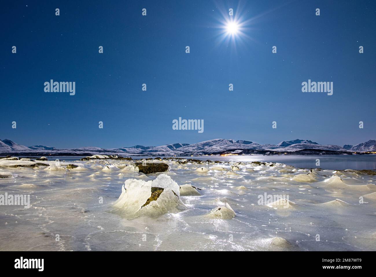 Frozen salt water under full moon, night in the Arctic in freezing conditions, extreme cold Stock Photo