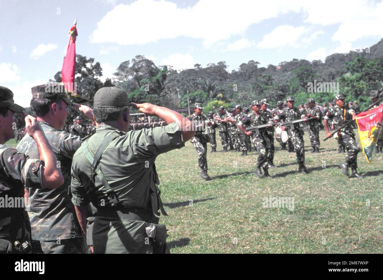 Servicemen marching with the Bolivian flag are saluted during closing