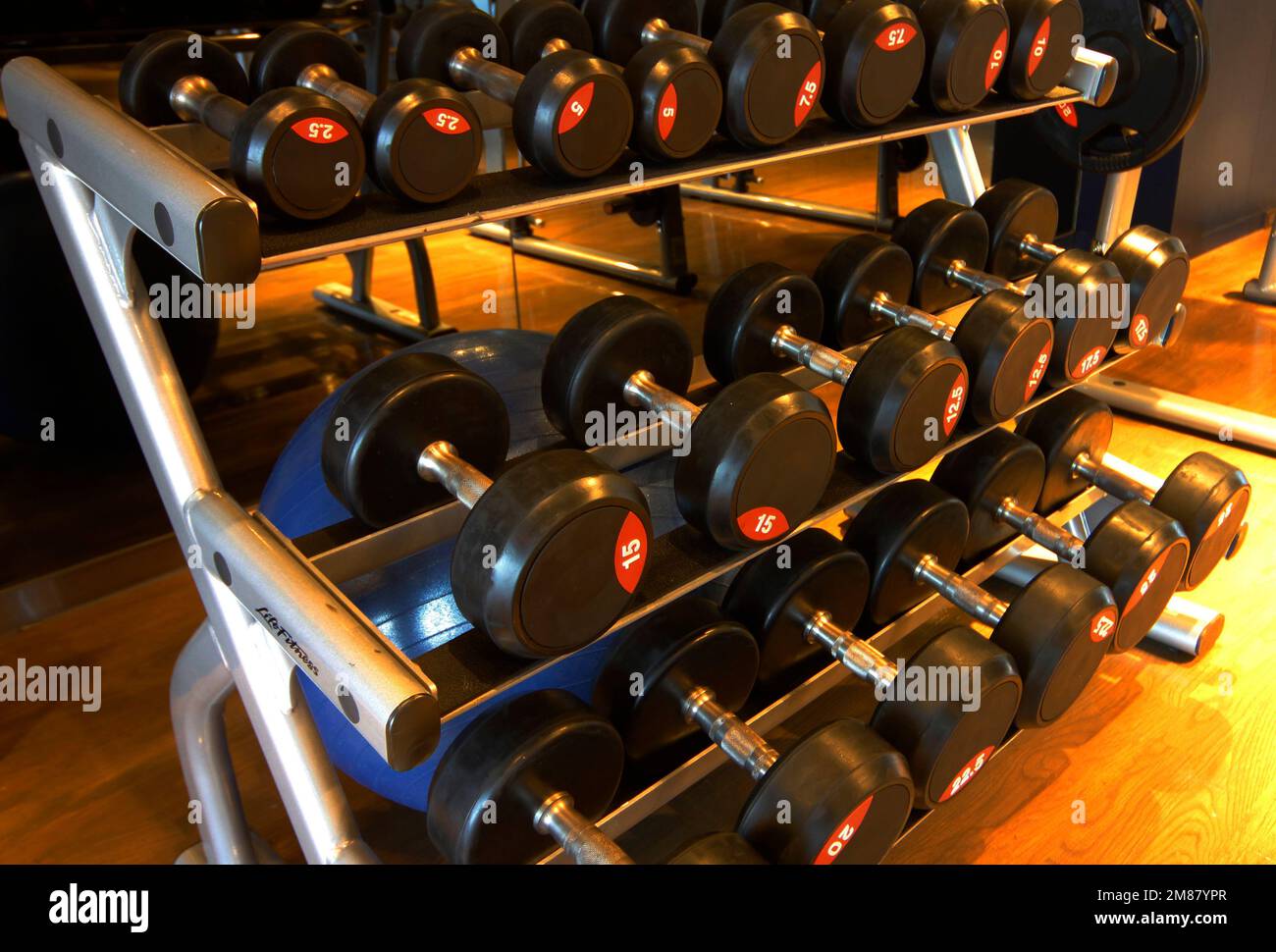 Assorted dumb-bells used for weight lifting Stock Photo