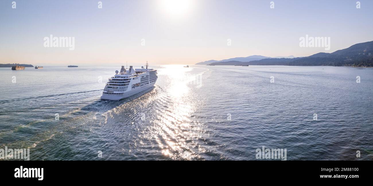 Cruise ship sailing out of Vancouver harbour at sunset, cruise line