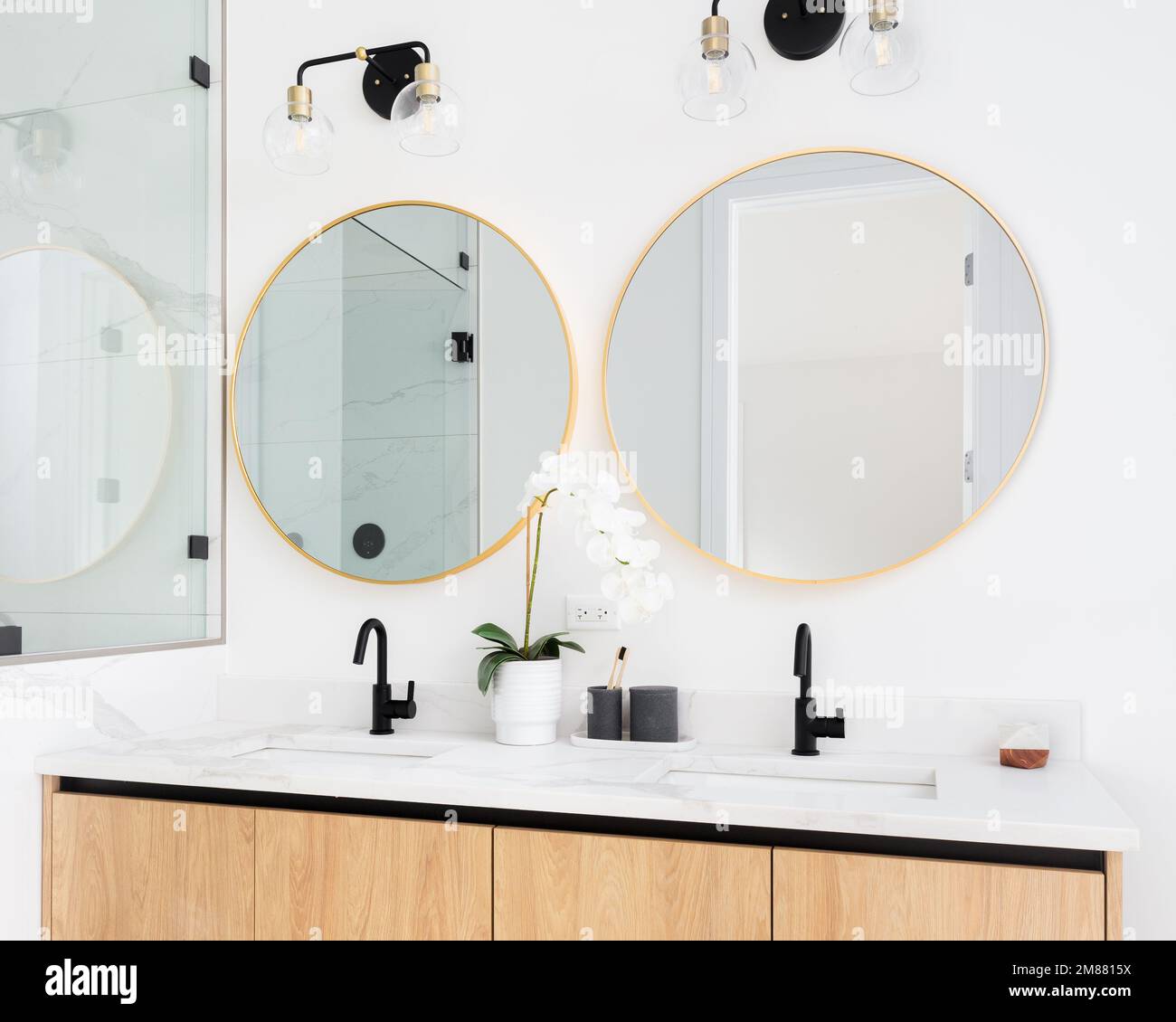 A beautiful bathroom with a wood marble countertop, and gold