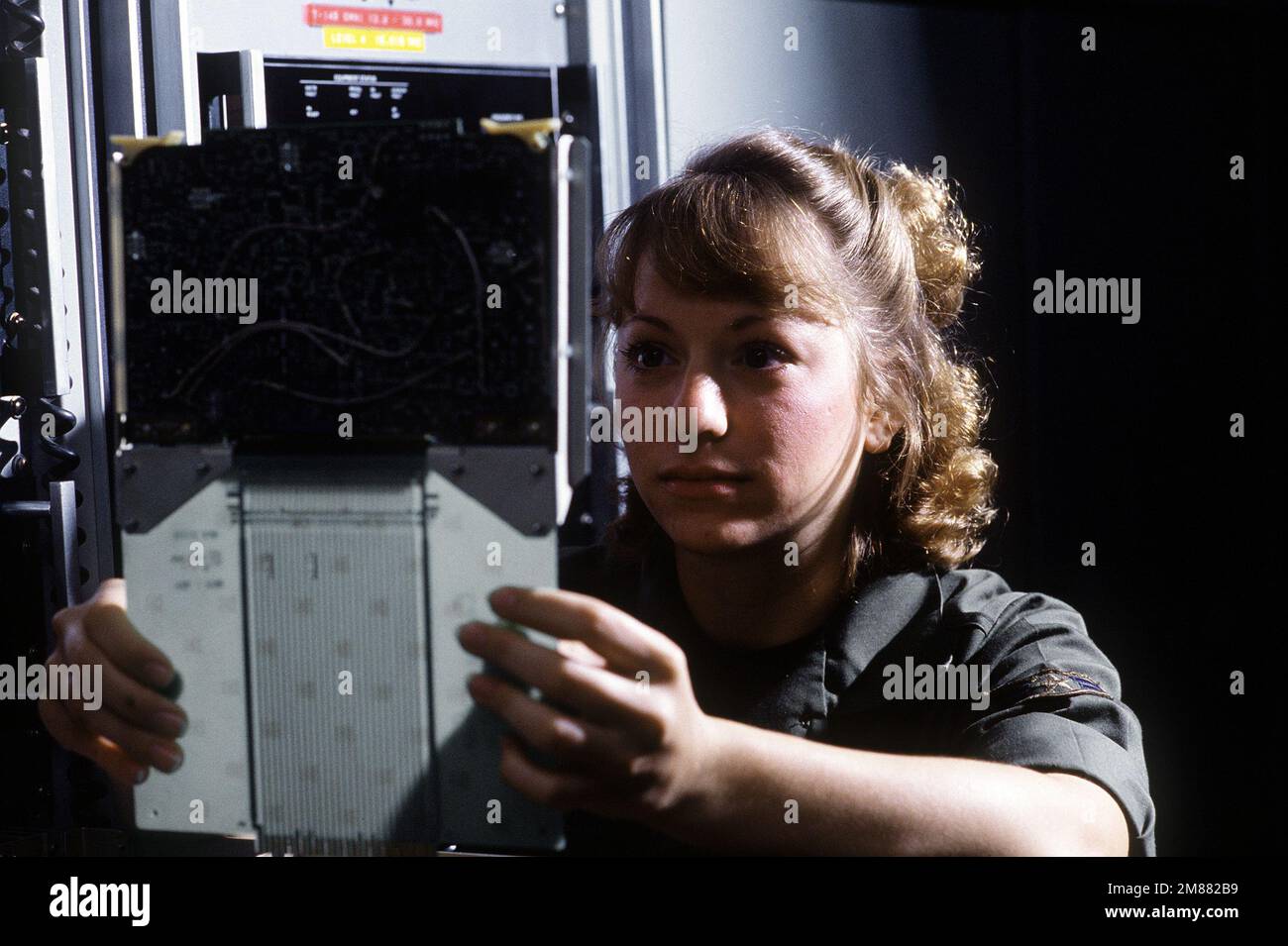 AIRMAN 1ST Class Julie Berry, a ground radio communications specialist of the 2006th Information Systems Group, inspects a channel A IF card used in radio transmitters. Base: Incirlik Air Base, Adana Country: Turkey (TUR) Stock Photo