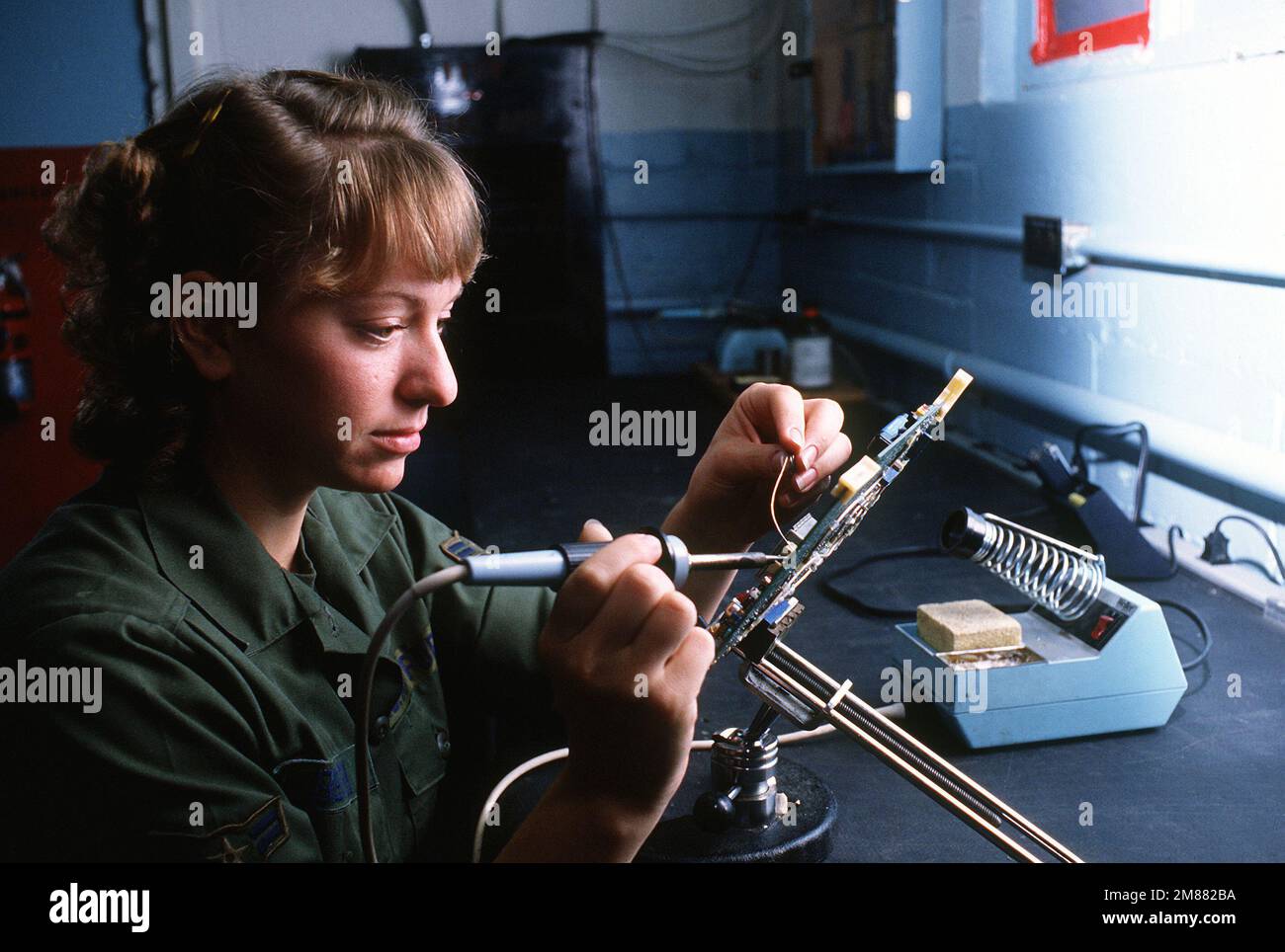 AIRMAN 1ST Class Julie Berry, a ground radio communications specialist of the 2006th Information Systems Group, solders a resistor on a channel A IF card at the ground radio maintenance shop. Base: Incirlik Air Base, Adana Country: Turkey (TUR) Stock Photo