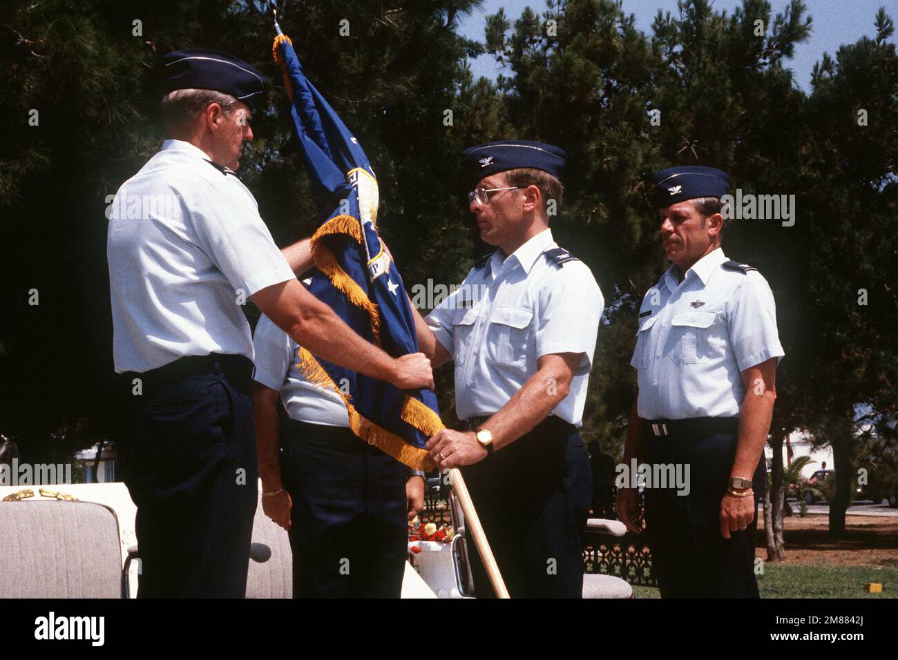 MAJ. GEN. Thomas A. Baker, left, commander, 16th Air Force, passes the unit colors of the 7276th Air Base Group to COL. Robert A. Hoffmann. Hoffmann is assuming command from COL. Michael T. Tagaras, right. Base: Iraklion Air Station State: Crete Country: Greece (GRC) Stock Photo