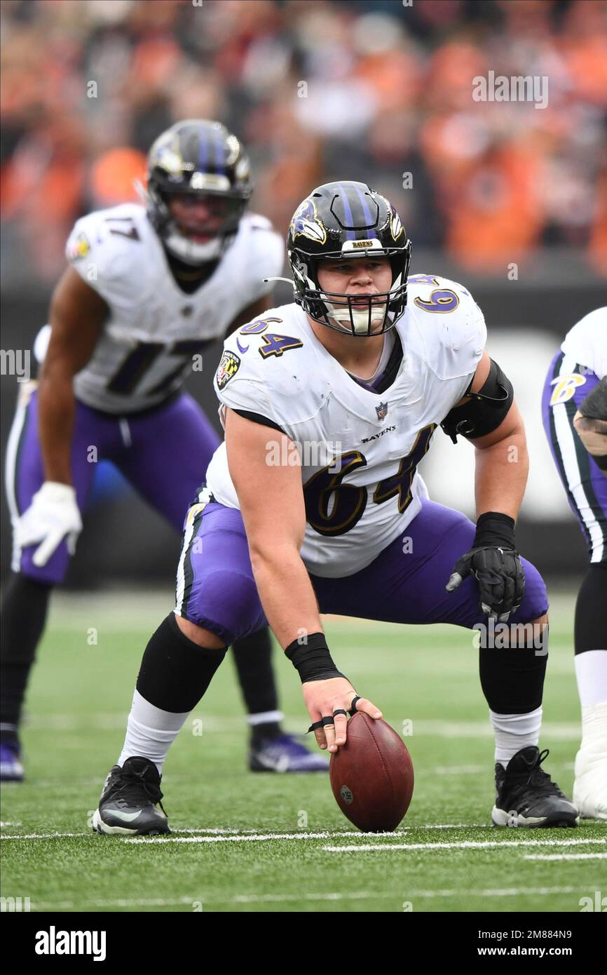 Baltimore Ravens center Tyler Linderbaum (64) lies on the field