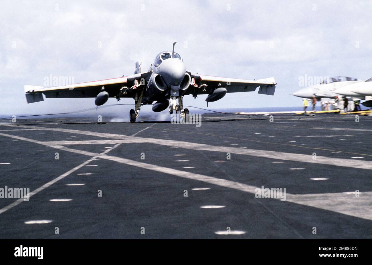 An A-6E Intruder aircraft lands on the flight deck of the aircraft ...