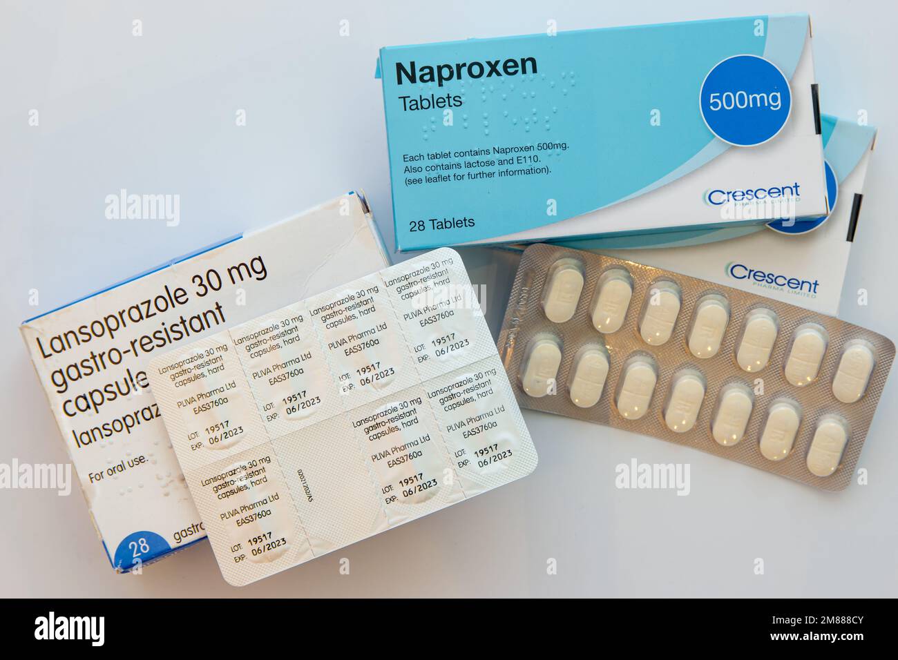 Box and blister pack of generic 500mg Naproxen tablets and 30mg Lansoprazole capsules, often prescribed together Stock Photo