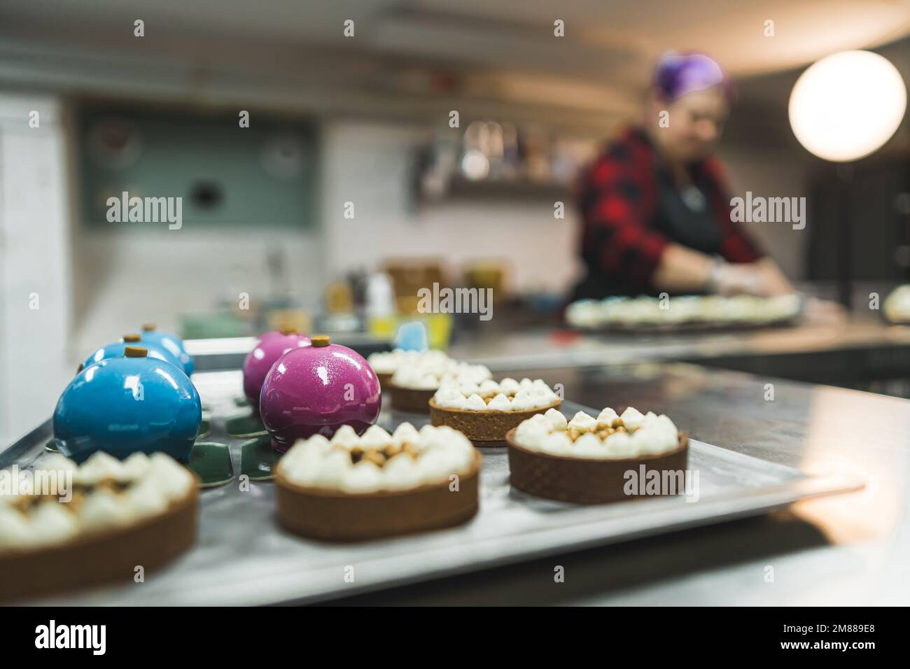 view of delicious baked cookies and a baker in the background, dessert concept. High quality photo Stock Photo