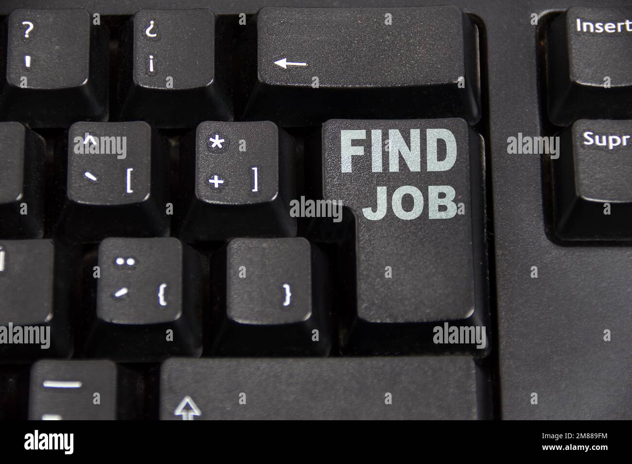 Closeup of a highlighted key on the keyboard of a laptop showing the