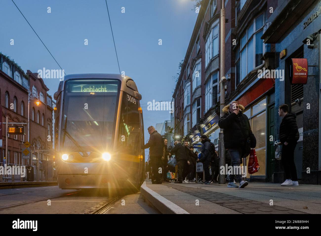 LUAS Tram and passengers at Abbey Street Station, RED Line, Dublin, Ireland. Stock Photo