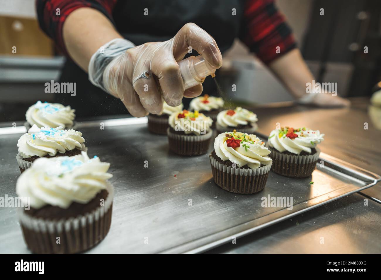 process of decorating cupcakes for New Year or Christmas dinner at the bakery, festive concept. High quality photo Stock Photo